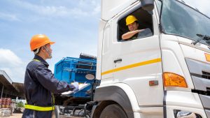 Commercial trucks on a multi-lane highway representing highway safety for all road users