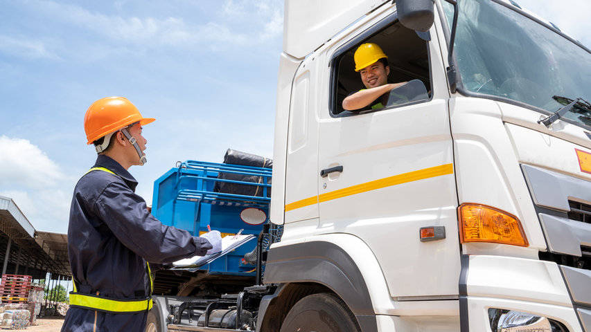 Commercial trucks on a multi-lane highway representing highway safety for all road users