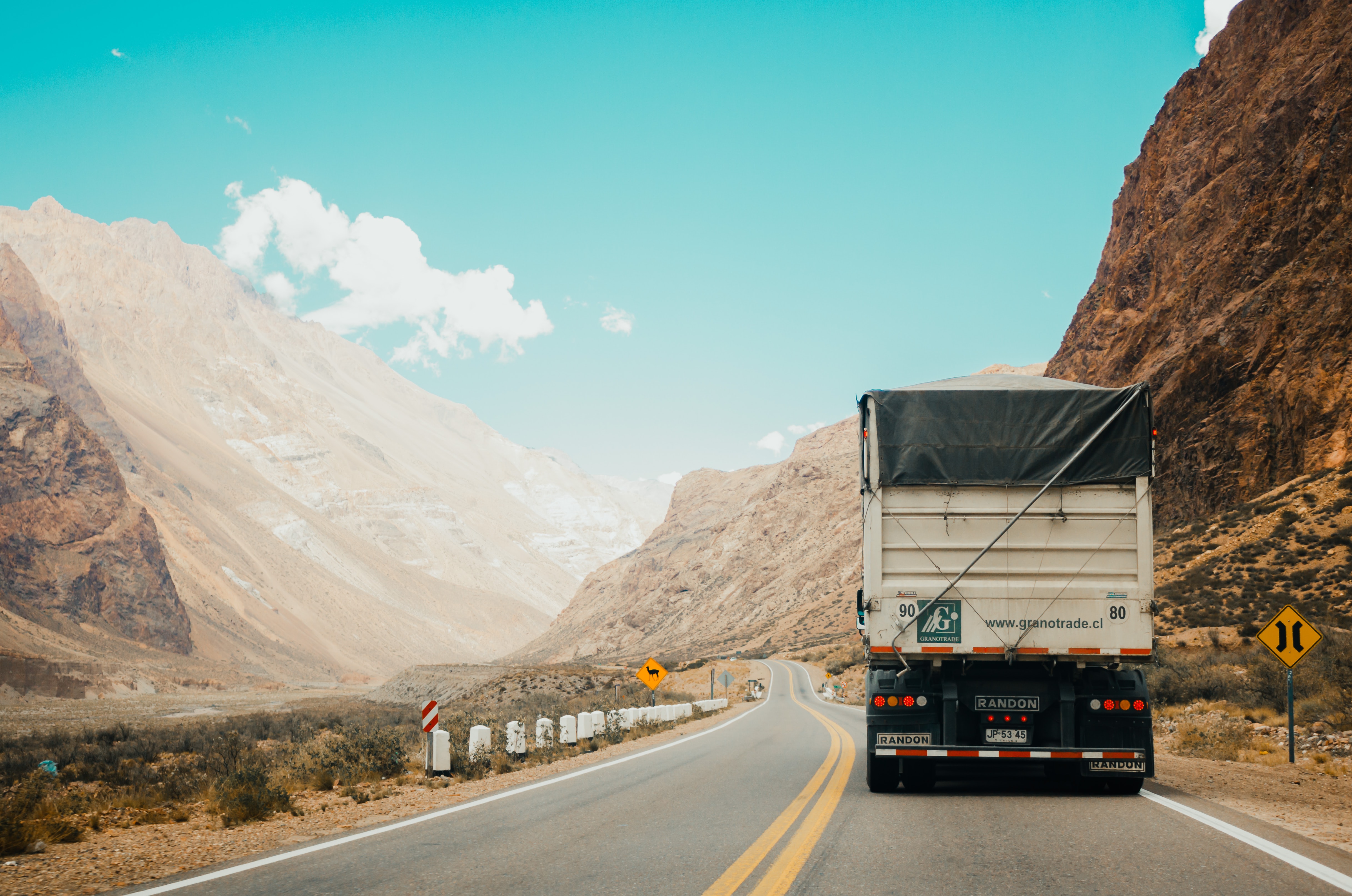 Semi truck driving on a winding mountain road